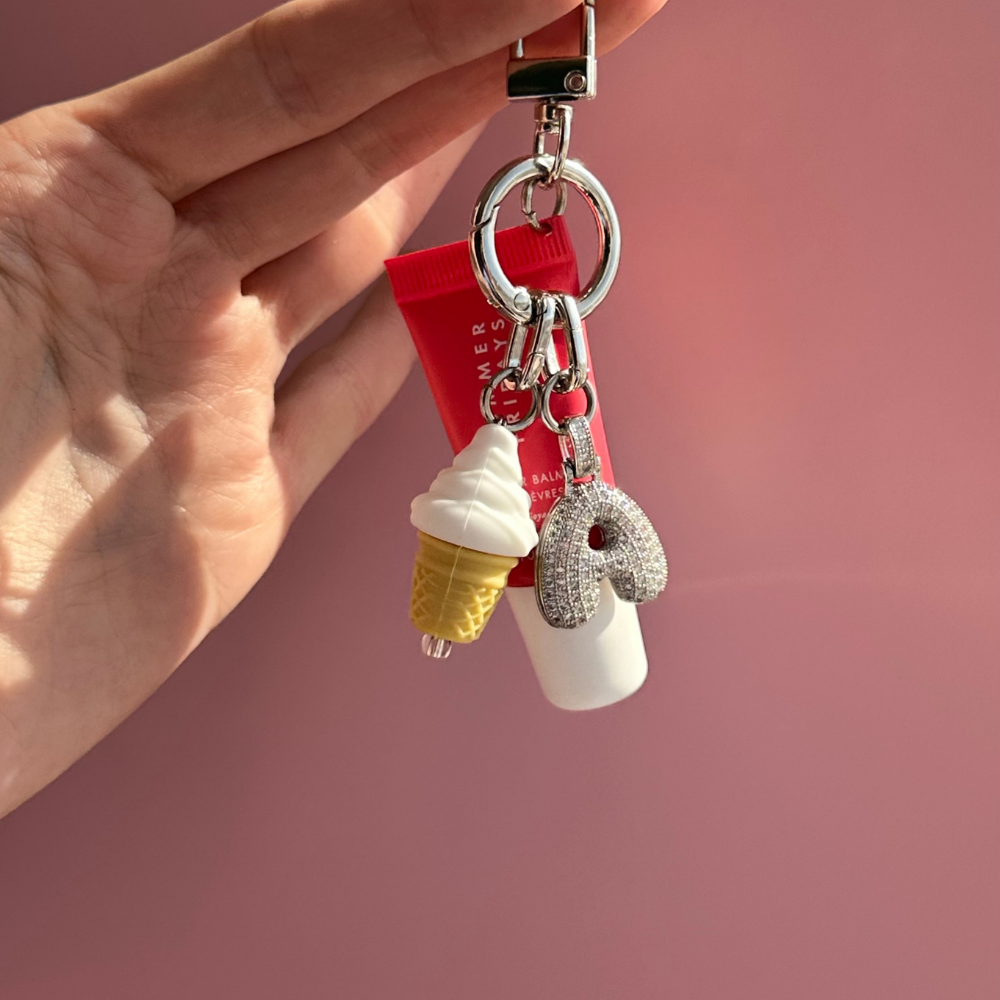 Soft-serve ice cream cone phone charm with a sparkly initial charm, Build A Caze.