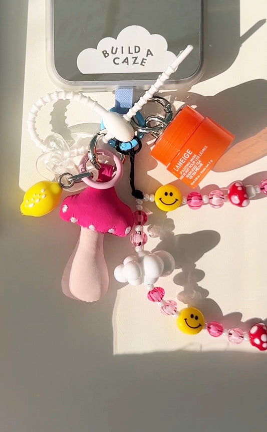Cute mushroom phone charm in a whimsical shroomy style, trendy Y2K aesthetic mobile accessory and decorative tech strap for phone cases by Build a Caze.