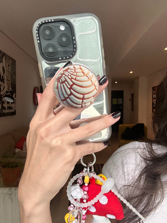 Little Conchita pink Mexican bread concha MagSafe pop holder, cute pan dulce inspired magnetic pop socket and phone grip accessory.