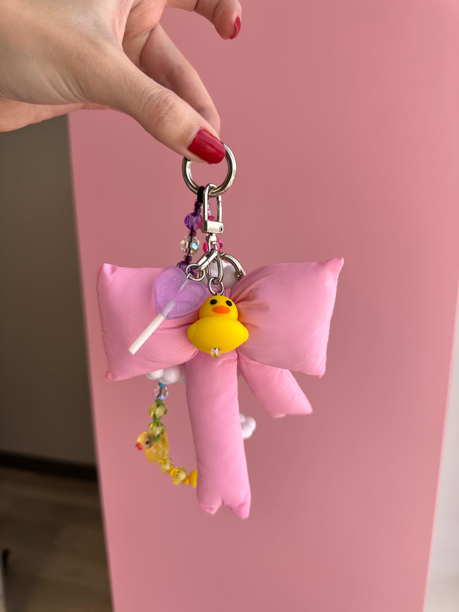 Cute lilac lollipop phone charm in a sweet candy style, nostalgic Y2K aesthetic mobile accessory and decorative tech strap by Build a Caze.