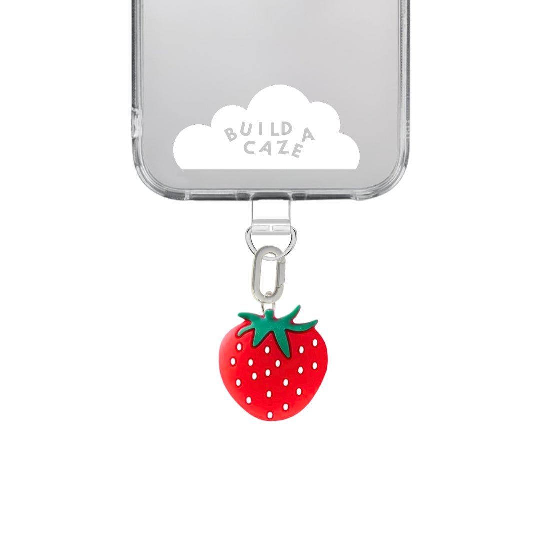 Cute red and green strawberry phone charm with a chunky fruit design, quirky Y2K aesthetic mobile accessory and decorative tech strap for phone cases by Build a Caze.