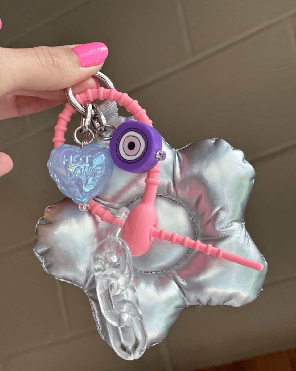 Pastel blue Hot Love heart charm shown with a purple evil eye charm, Build A Caze.
