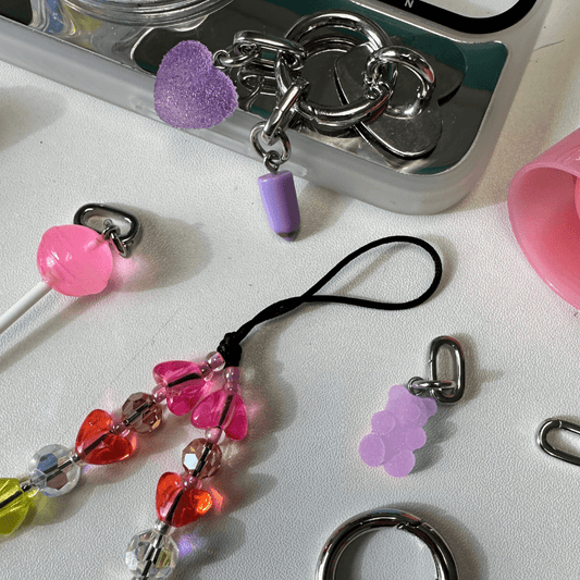 Adorable lilac bubble bear phone charm with a 3D translucent design, trendy Y2K aesthetic mobile phone accessory and decorative tech strap by Build a Caze.
