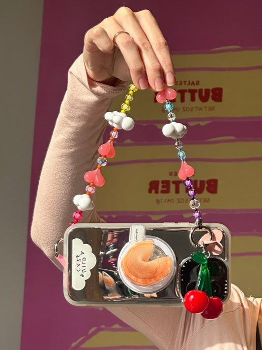 Beaded phone wrist strap featuring pink and multicolor rainbow beads with heart and cloud charms and a black cord lanyard, perfect as a decorative phone strap and mobile phone accessory.