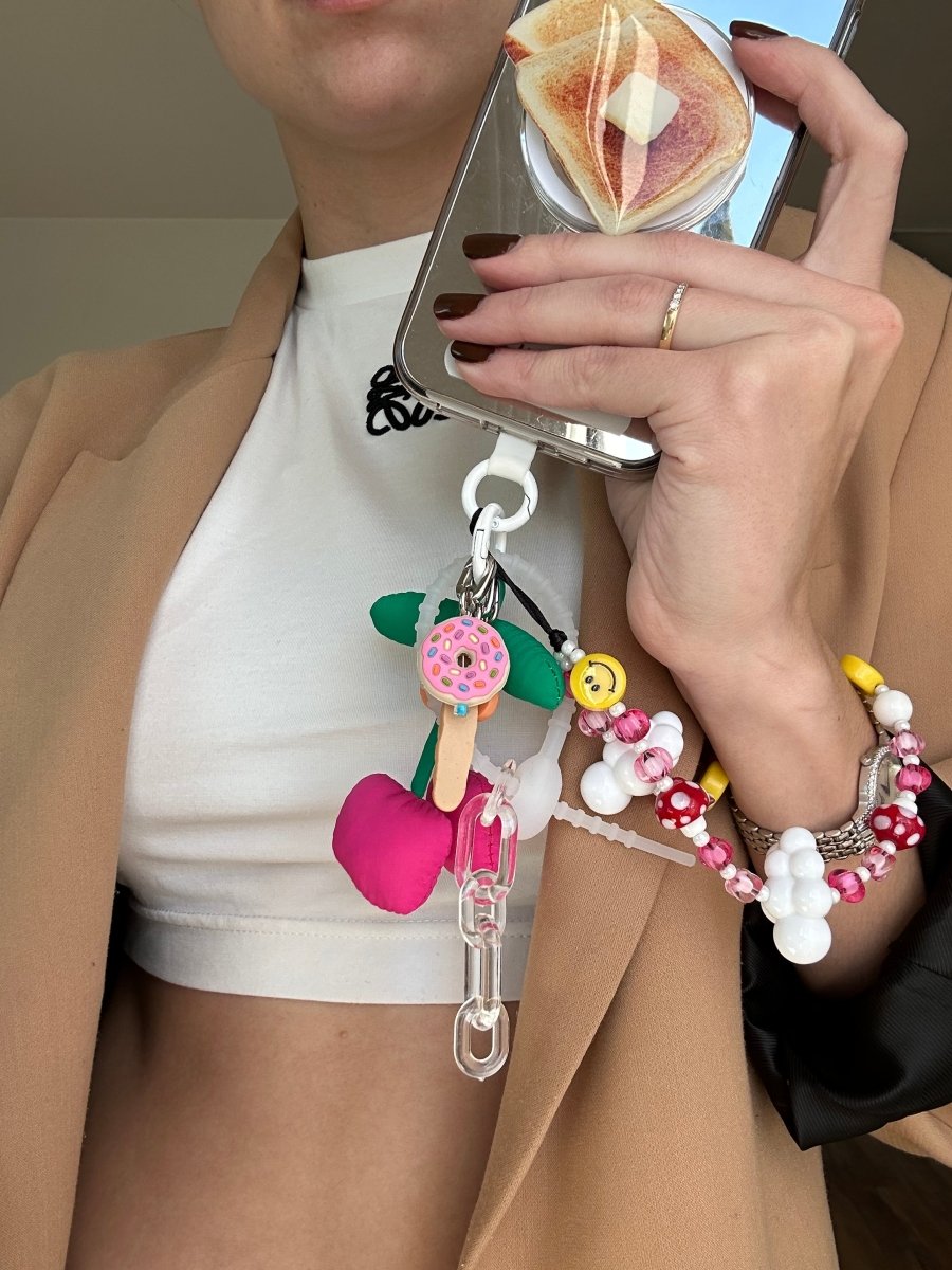 Phone wrist strap pink, red, and yellow mushroom and smiley face charms with white cloud beads Build A Caze