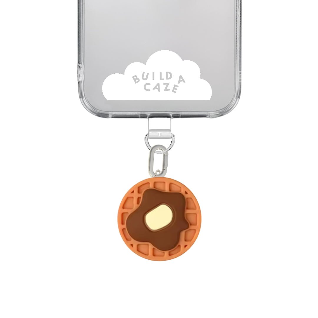 Playful brown and pink waffle shaped phone charm with a sweet foodie aesthetic, a cute Y2K inspired 3D dessert accessory and decorative mobile strap by Build a Caze.