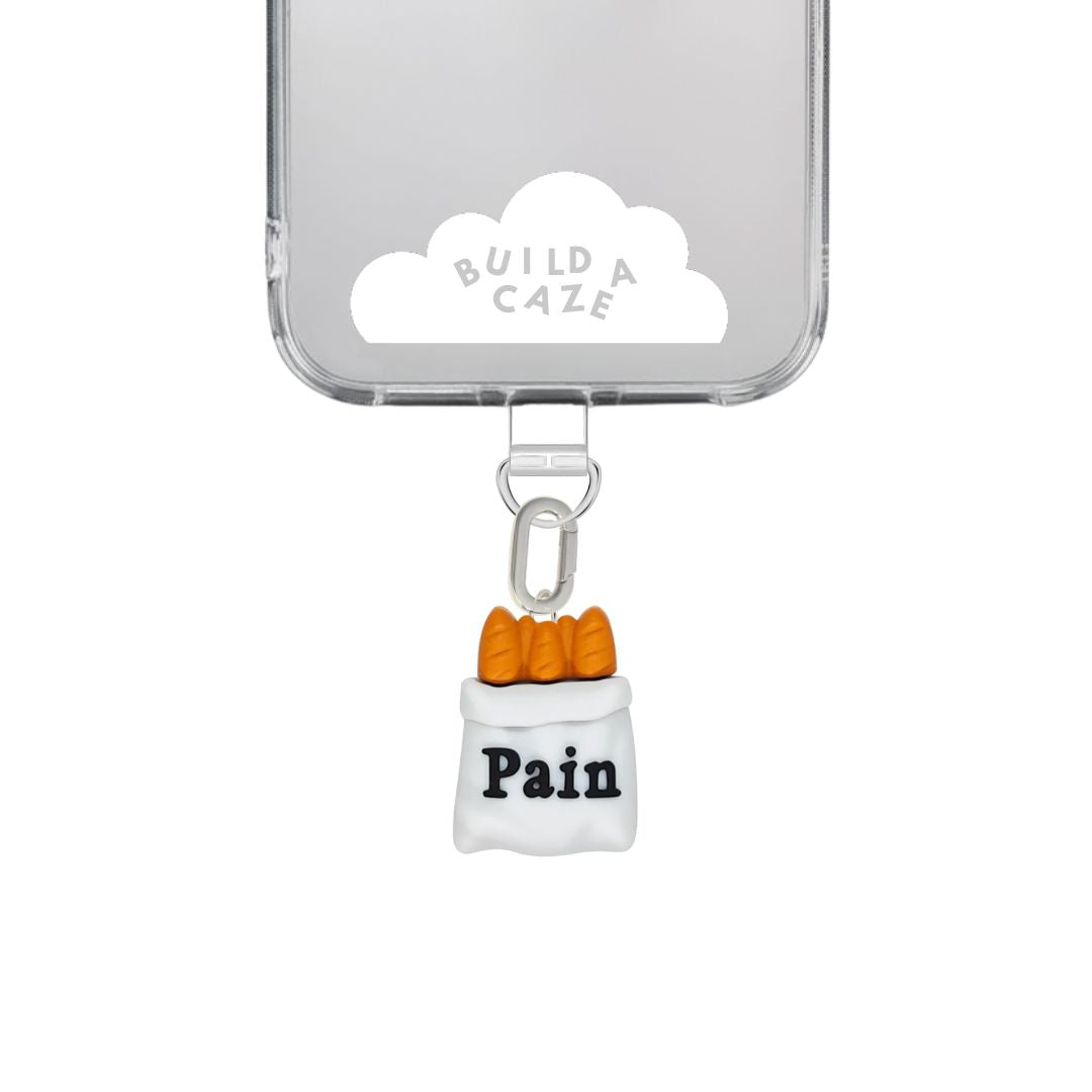 Adorable 3D baguette phone charm in a brown crunchy bread style, unique Y2K aesthetic mobile accessory and decorative tech strap for phone cases by Build a Caze.