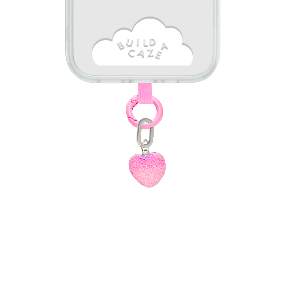 Pink heart-shaped gummy phone charm with a gradient tone, cute Y2K aesthetic mobile accessory and decorative tech strap for phone cases by Build a Caze.
