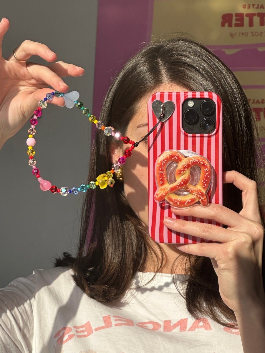 Beaded phone wrist strap featuring multicolor rainbow beads, heart charms, and a yellow ducky on a black cord lanyard, perfect as a decorative phone strap and mobile phone accessory.