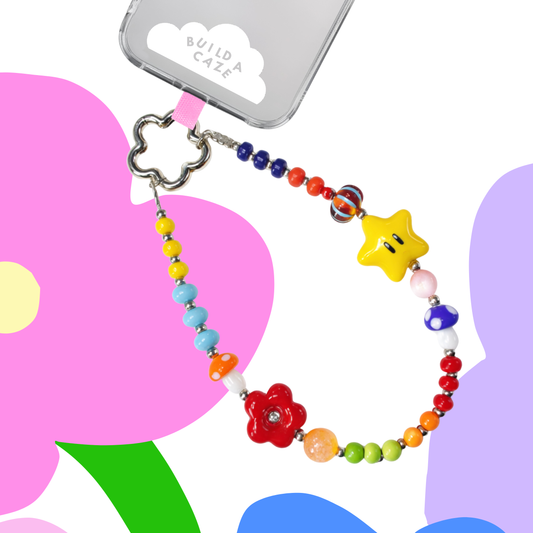 Retro-inspired rainbow phone strap and wristlet featuring star, mushroom, and flower beads. A playful beaded phone charm and tech accessory for bags and Kindle.