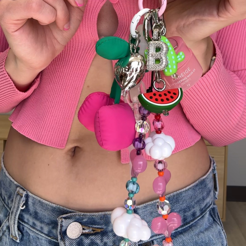 Watermelon slice phone charm shown with a cherry and cactus charm, Build A Caze.