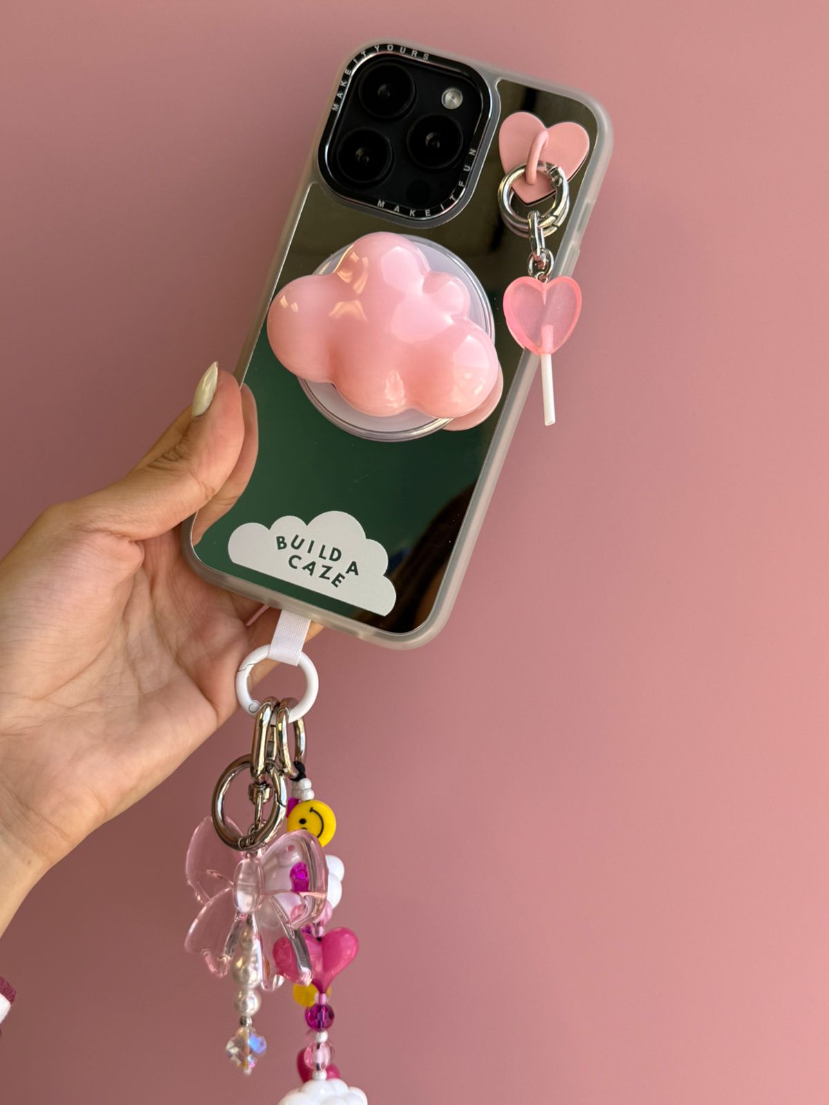 Pink Coral Pink Lollie Pop Charmie charm and dangly accessory shown attached to a phone - Build A Caze