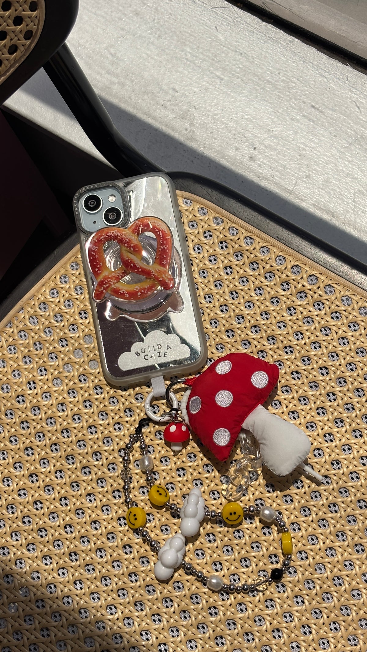 Handmade green and orange mushroom phone charm with a whimsical toadstool design, cute cottagecore aesthetic mobile accessory and beaded tech strap for phone cases by Build a Caze.