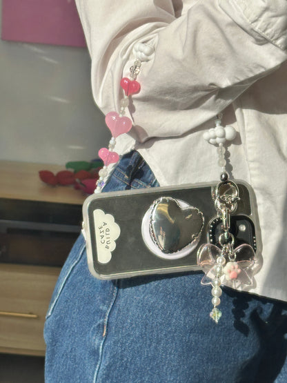Silver heart pop balloon MagSafe pop holder, metallic silver heart-shaped magnetic pop socket and phone grip accessory.