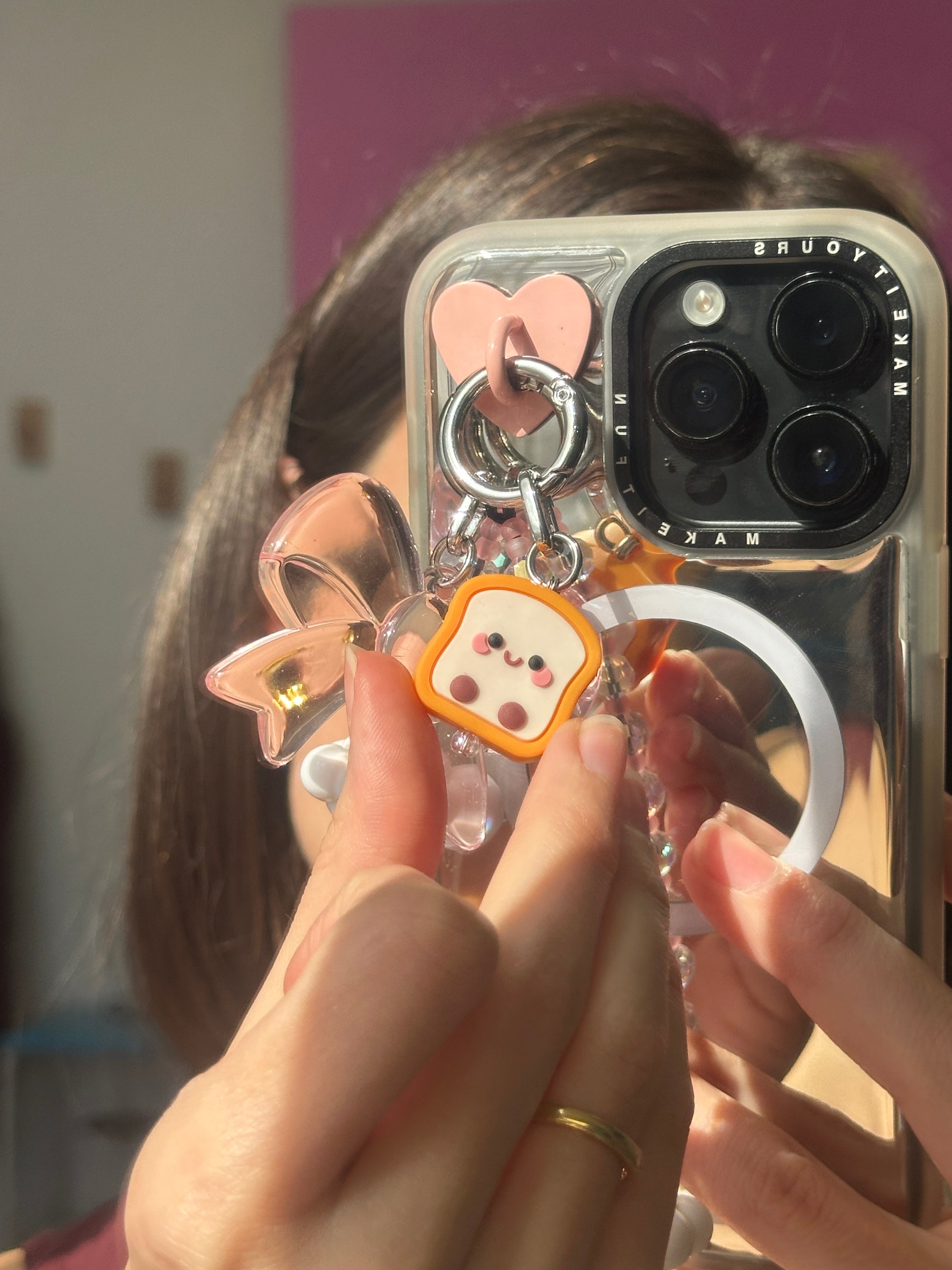 Cute 3D toast phone charm with a smiling face, bestie-themed bread accessory for mobile cases and Y2K aesthetic tech styling by Build a Caze.