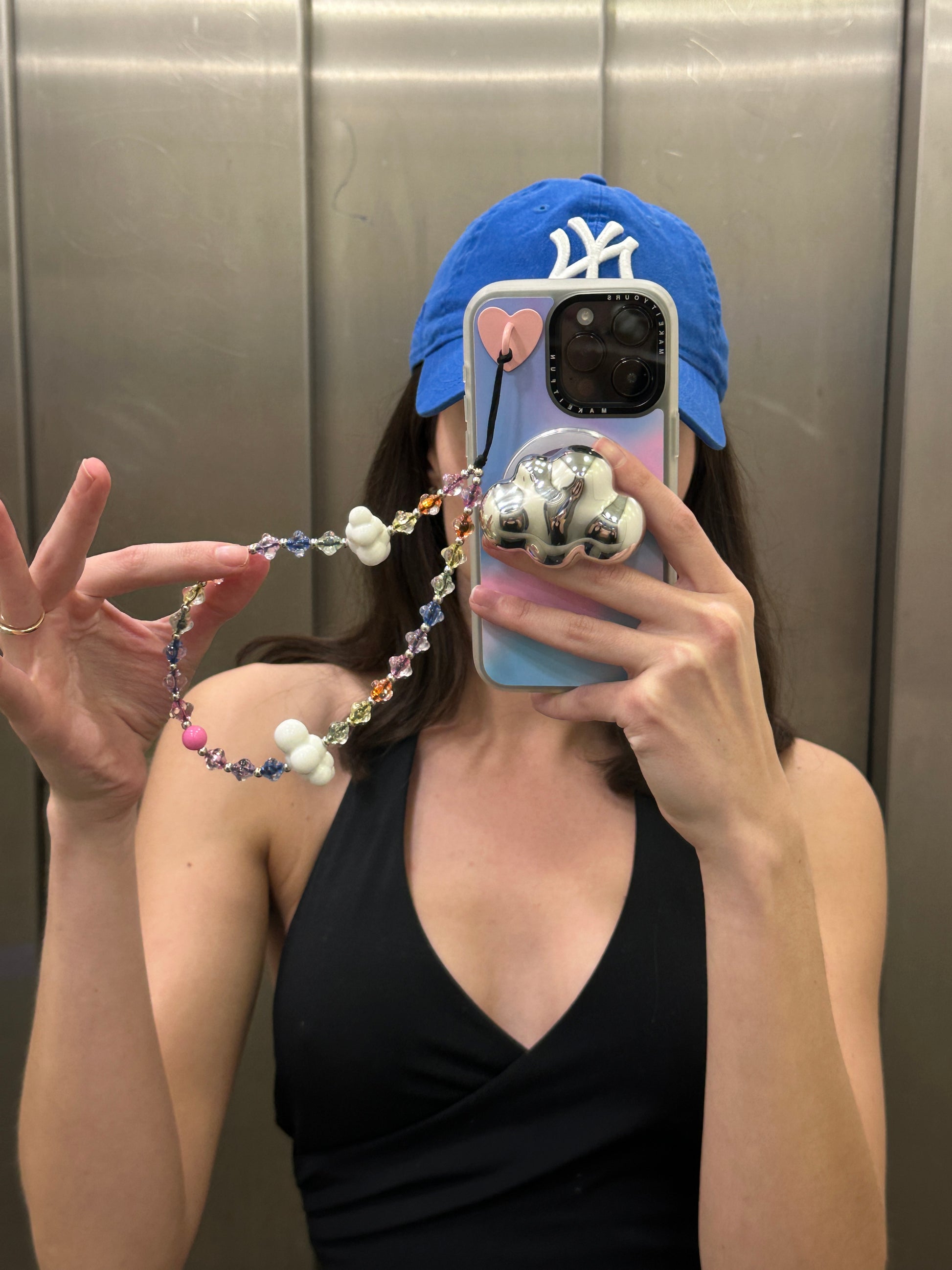 Beaded phone wrist strap featuring a black cord lanyard and translucent colorful rainbow beads, perfect as a decorative phone strap and mobile phone accessory.