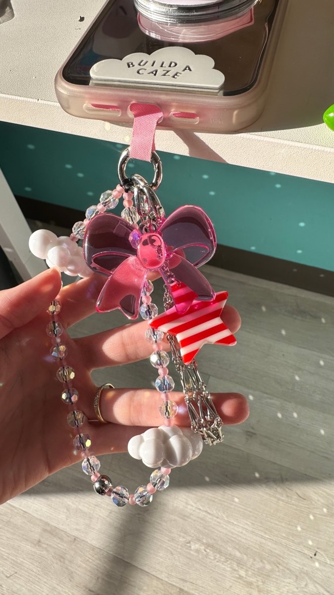 Silver metallic mesh B.A.C. Lippie Clippie keychain and lipstick holder accessory for phone cases, designed for stylish hands-free carry.
