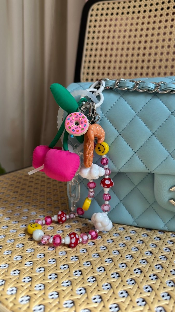 Happy face phone charm with a yellow smiley bead, cute Y2K aesthetic mobile accessory and decorative tech strap for phone cases by Build a Caze.
