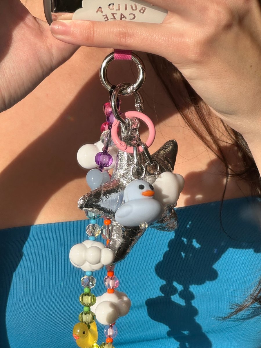 Cute blue ducky phone charm with a mini rubber duck design, nostalgic Y2K aesthetic mobile accessory and decorative tech strap for phone cases by Build a Caze.