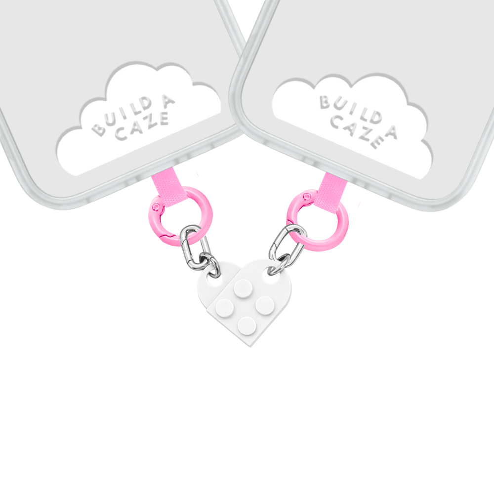 Pink and white heart-shaped beaded phone charm with a Y2K aesthetic, featuring a durable strap for mobile case decoration and a trendy Build in Love accessory style by Build a Caze.