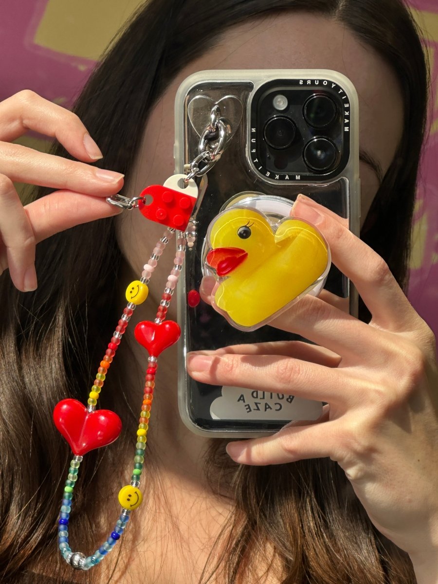 Beaded phone wrist strap featuring colorful rainbow beads and happy smiley face charms attached to a black cord lanyard, perfect as a decorative phone strap and vibrant mobile phone accessory.