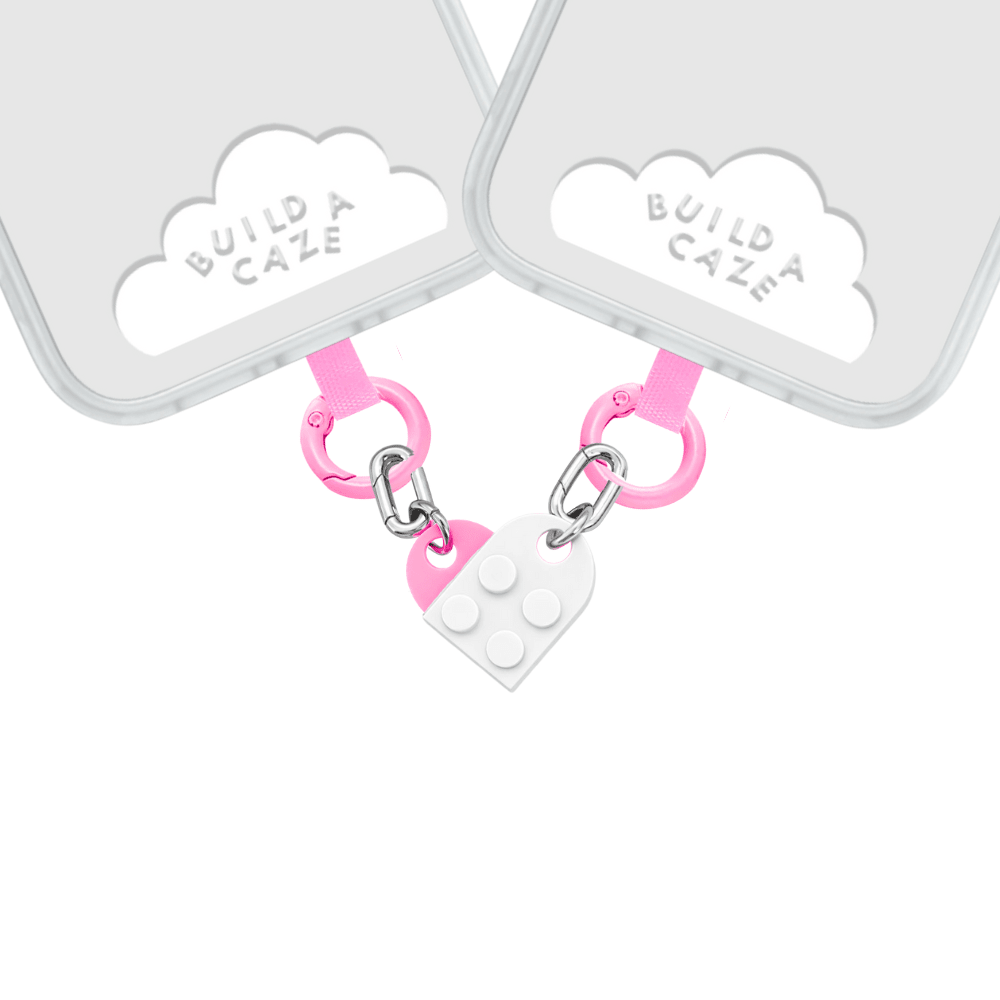 Elegant all-white heart-shaped phone charm with a minimalist aesthetic, featuring a durable beaded strap for mobile case decoration and trendy Y2K tech styling by Build a Caze.