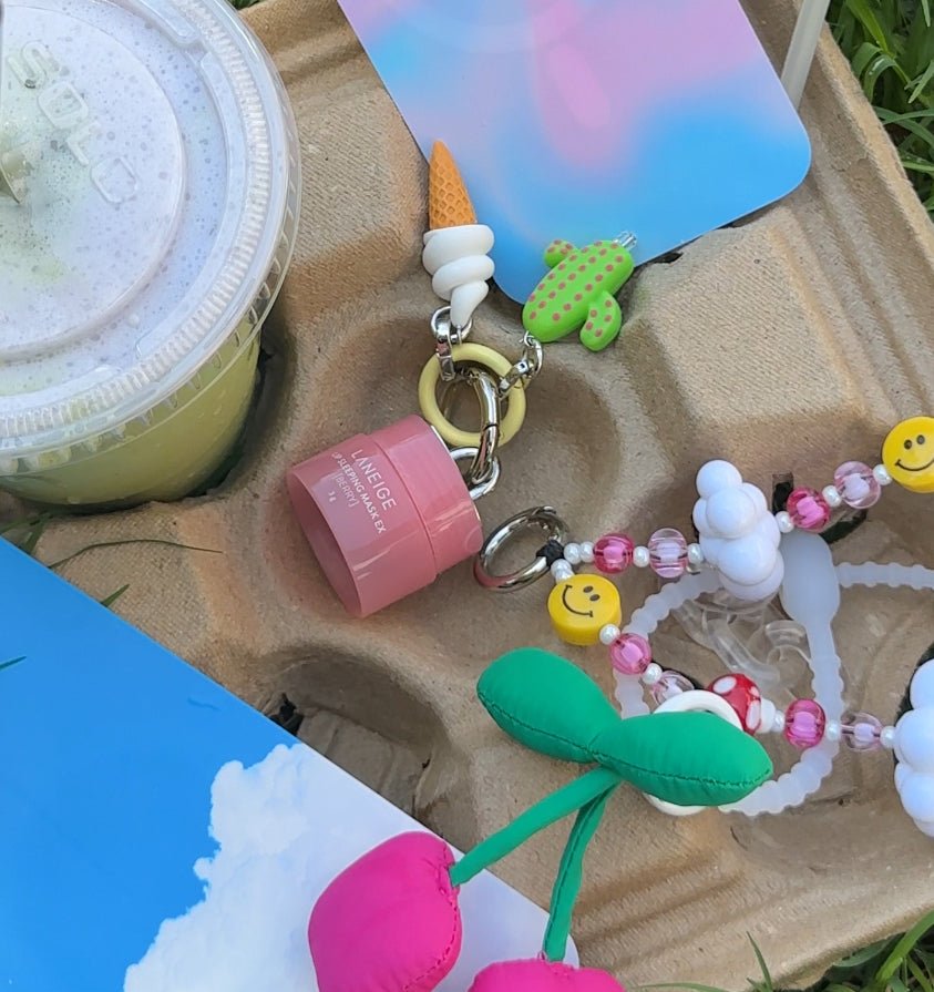 Classic vanilla ice cream scoop phone charm with a realistic 3D texture, cute food-themed mobile accessory for Y2K aesthetic phone cases and trendy tech styling by Build a Caze.