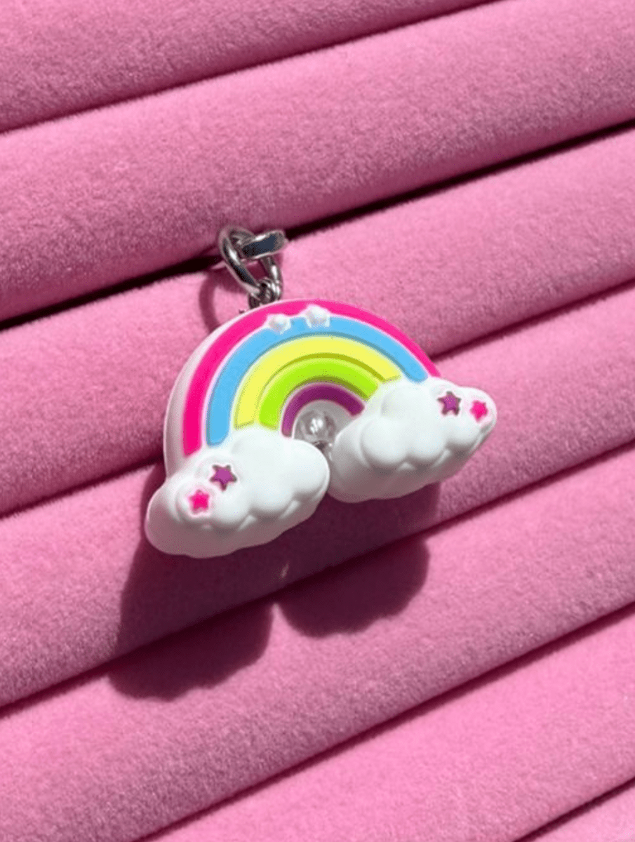 Rainbow phone charm with smiley flower clouds in pink and yellow, Build A Caze.