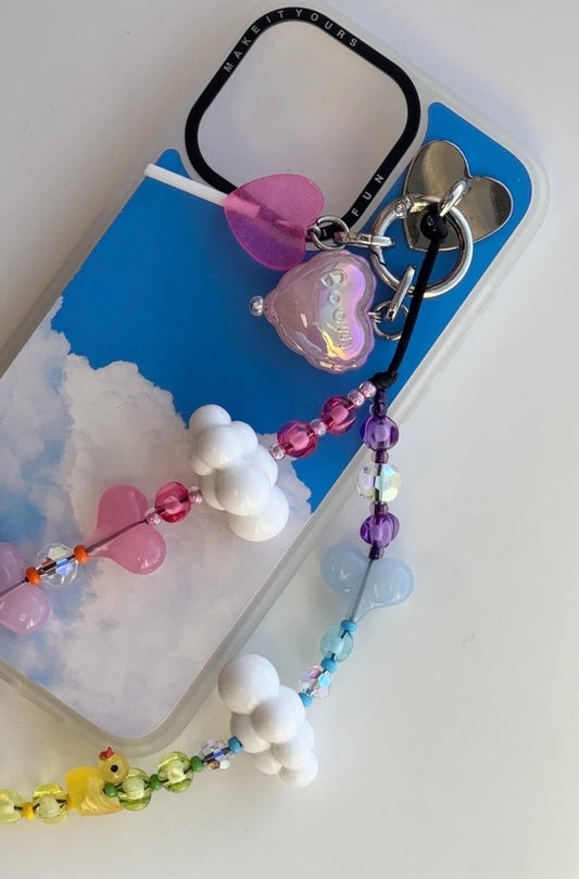 Beaded phone wrist strap featuring cute yellow duck charms, white cloud beads, and a black cord lanyard, perfect as a decorative phone strap and mobile phone accessory.