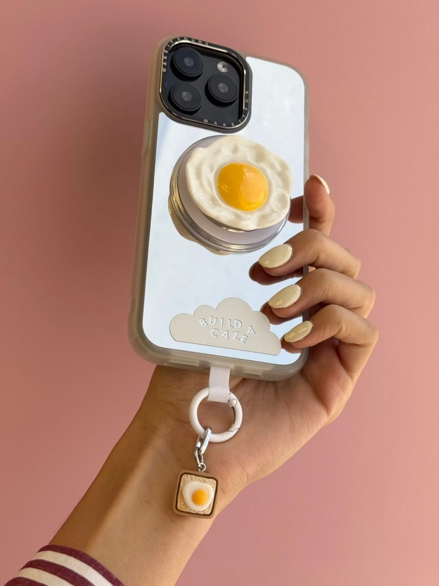 White and brown Eggie Toast Bites Charmie charm and dangly accessory shown from a close-up angle - Build A Caze