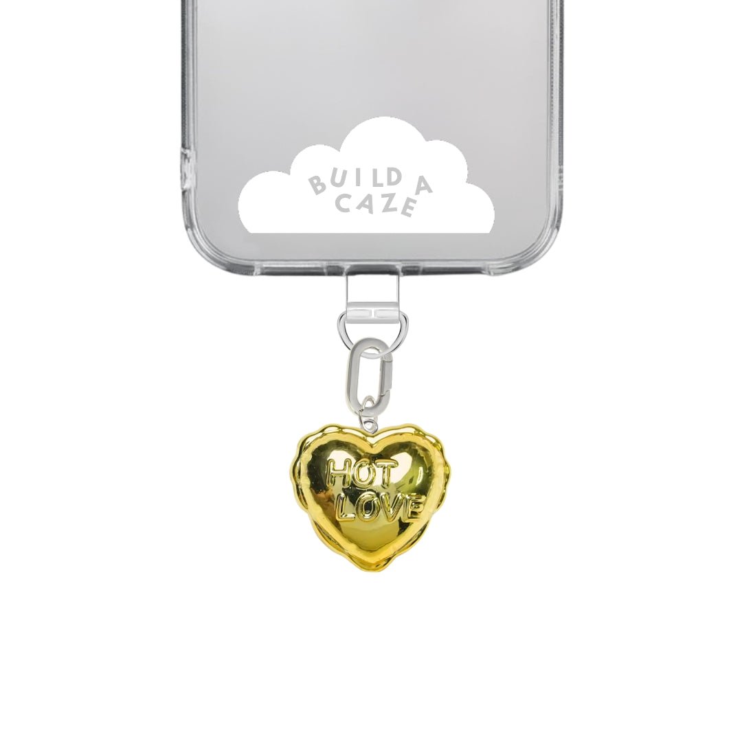Gold heart-shaped balloon phone charm with a playful Y2K aesthetic, quirky 3D balloon texture, and romantic Valentine's Day style, cute mobile accessory by Build a Caze.