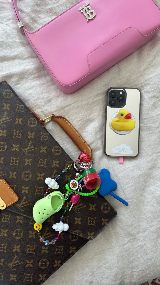 Green Crokie charm keychain, cute green character phone case accessory, trendy bag charm for mobile devices, decorative tech attachment, stylish emerald green charmie for custom phone cases.