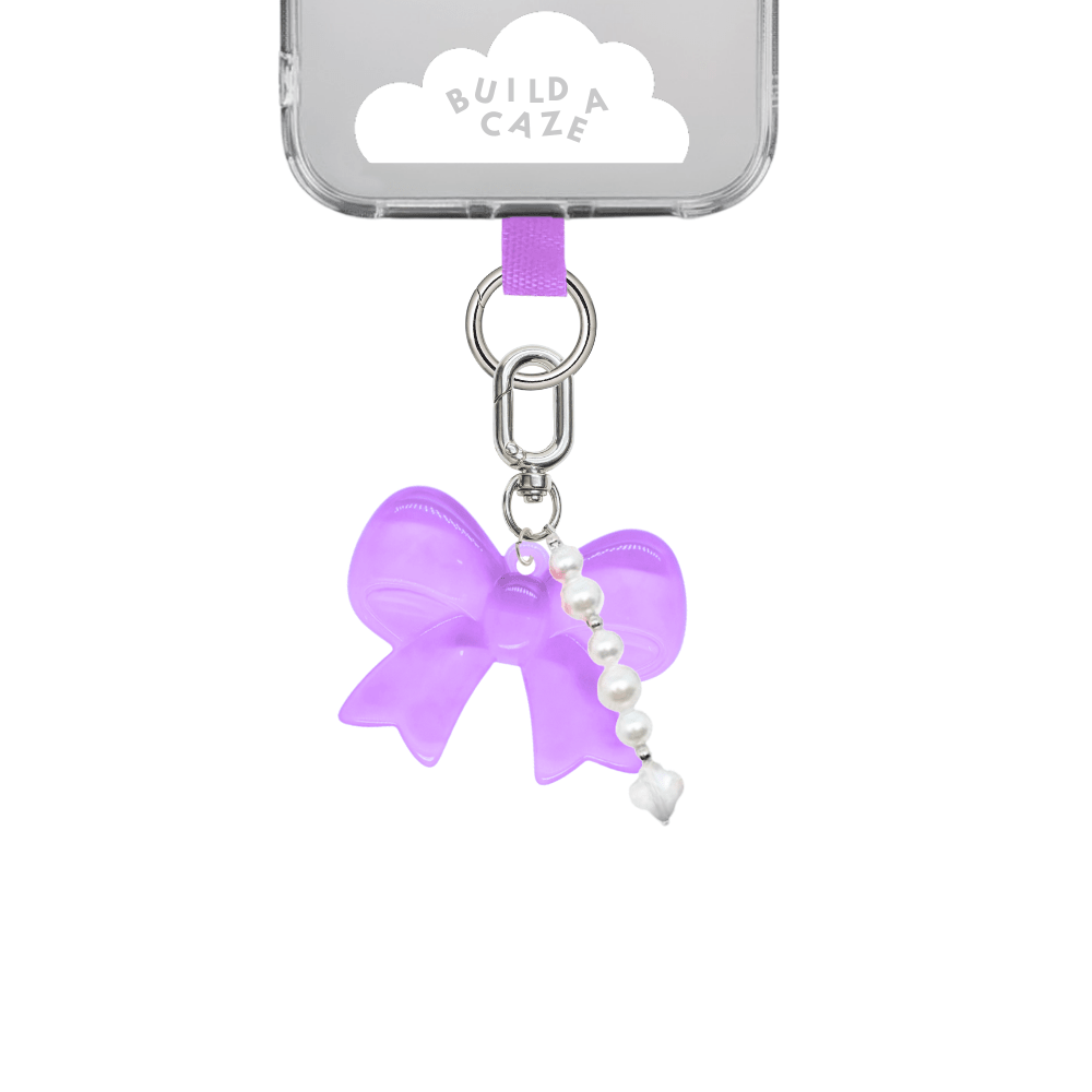 Gummy Purple Bow U Keychain, light purple bow shaped charm with dainty pearls, cute mobile phone case accessory, stylish bag charm, decorative keychain for phone looks and backpacks.