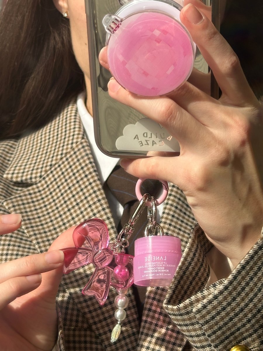 Laneige Mini Lip Glowy Balm keychain and phone charm accessory, cute pink lip balm holder for mobile cases and bags, travel size glossy lip treatment attachment with decorative beads and heart charms.