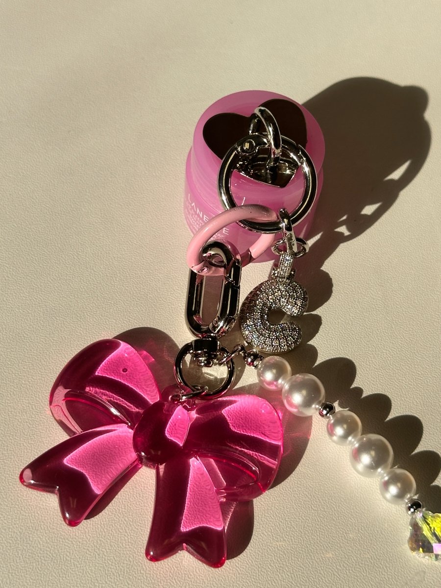 Laneige mini lip gloss charmie keychain, moisturizing lip balm accessory for phone cases and bags, cute skincare-inspired mobile charm, portable beauty product attachment.