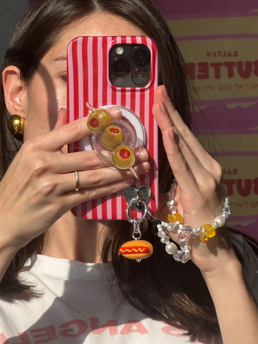 Quirky hot dog phone charm with mustard detail, miniature 3D food accessory for mobile cases and Y2K aesthetic tech styling by Build a Caze.