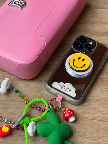 Iconic smile MagSafe pop holder, classic yellow happy face magnetic pop socket and phone grip accessory.