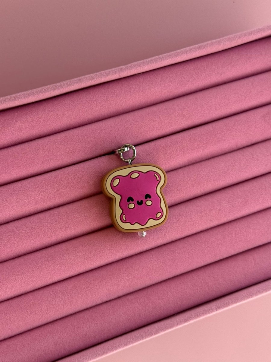 Raspberry Pink Jammy Toastie Charmie displayed on a pink stand Build A Caze