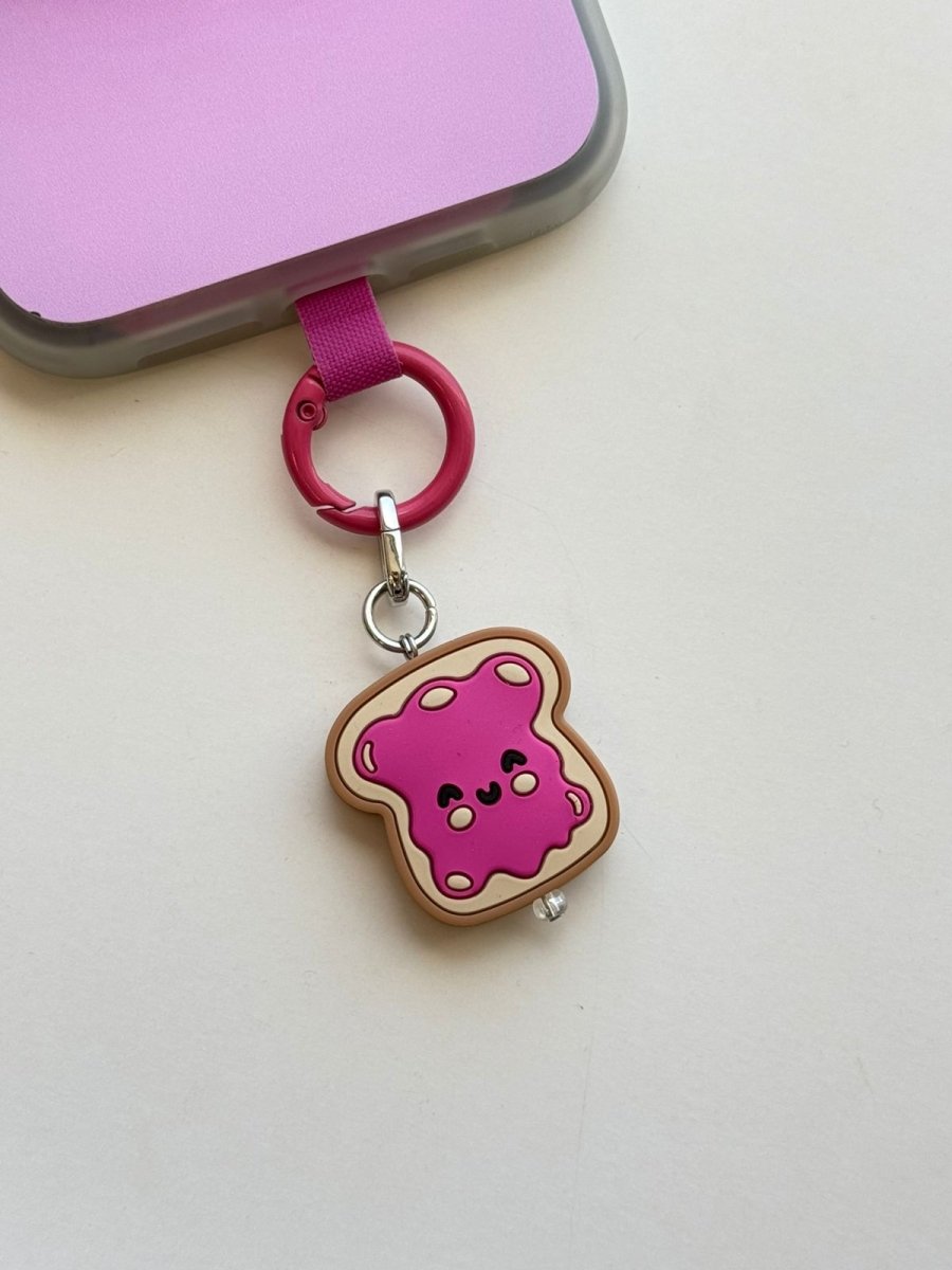 Raspberry Pink Jammy Toastie Charmie pink clip attached to a phone, close-up side angle | Build A Caze