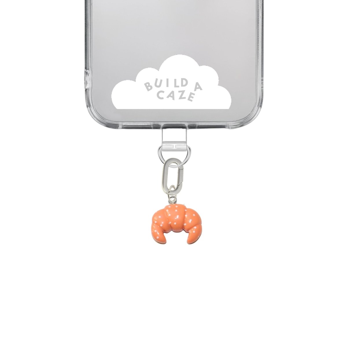 Realistic 3D croissant phone charm in golden brown and beige, cute French bakery-inspired mobile accessory and Y2K aesthetic tech strap for phone cases by Build a Caze.