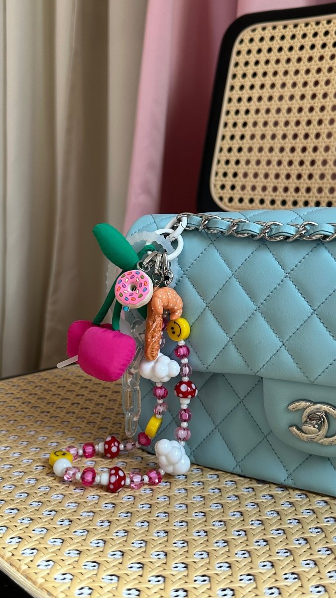 Detailed 3D croissant phone charm with a golden-brown finish, cute food-themed mobile accessory and Y2K aesthetic tech strap for phone cases by Build a Caze.