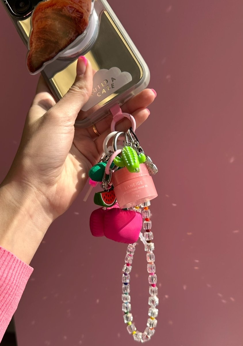 Laneige Mini Lip Gloss Charmie in Sweet Candy, miniature lip balm keychain for phone cases and bags, cute pink lip gloss accessory, portable candy-scented lip balm charm for mobile phones.