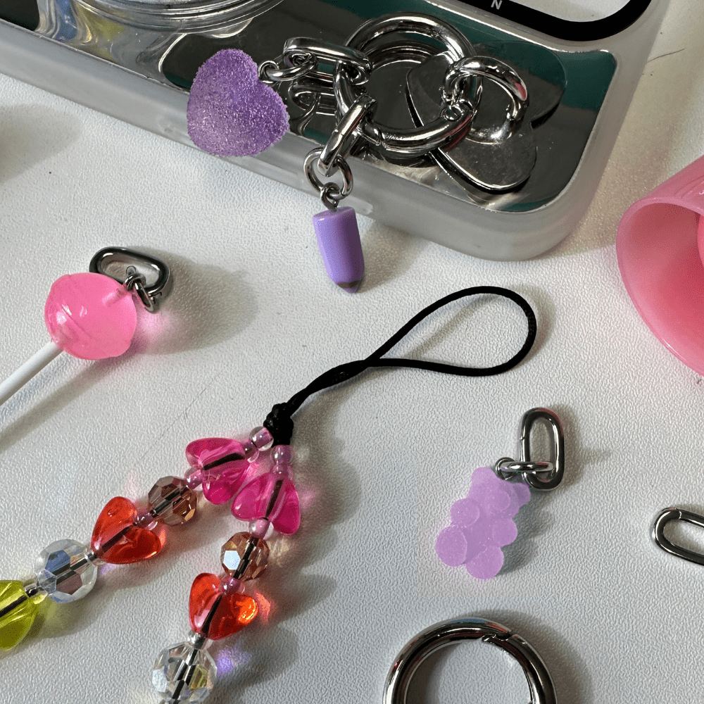Adorable lilac bubble bear phone charm with a 3D translucent design, trendy Y2K aesthetic mobile phone accessory and decorative tech strap by Build a Caze.