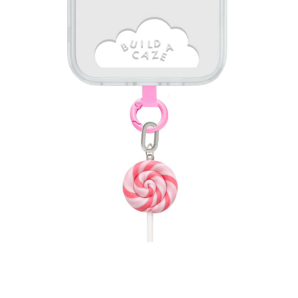 Pink swirl lollipop phone charm with a heart detail, cute Y2K aesthetic candy-themed mobile accessory and decorative tech strap by Build a Caze.