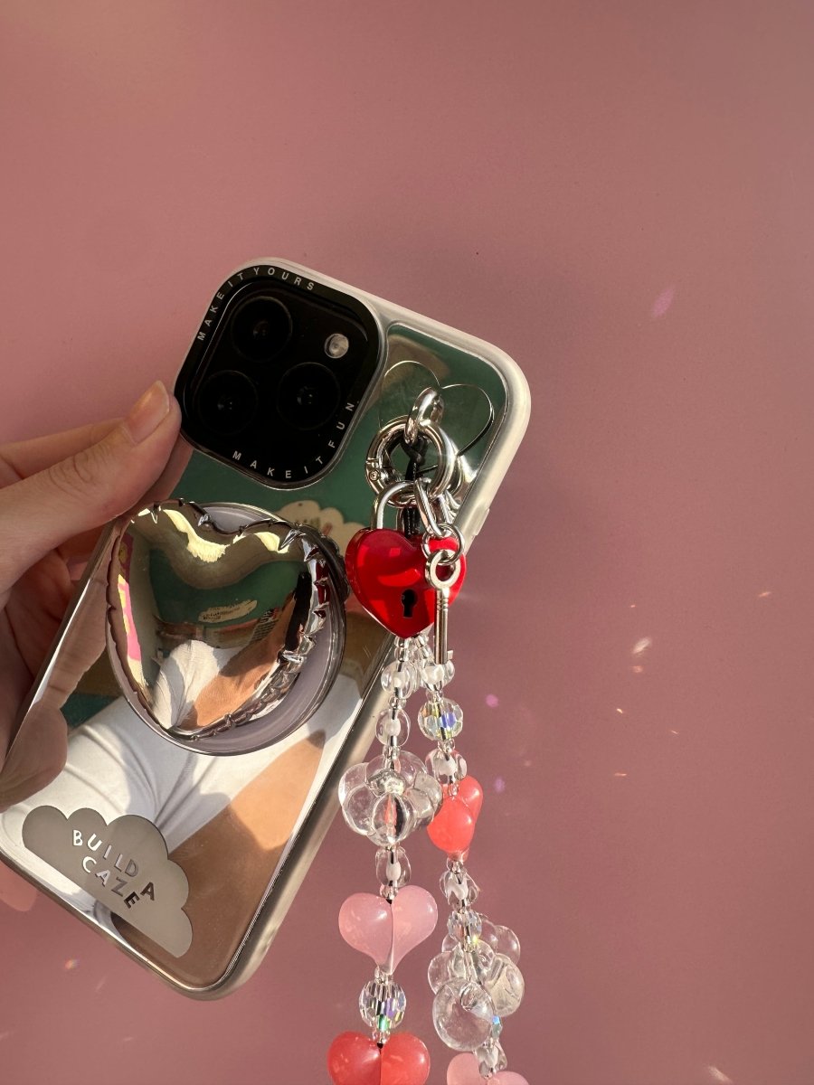 Pink heart lock phone charm in a cute Y2K aesthetic, nostalgic mobile phone case accessory and decorative tech strap by Build a Caze.