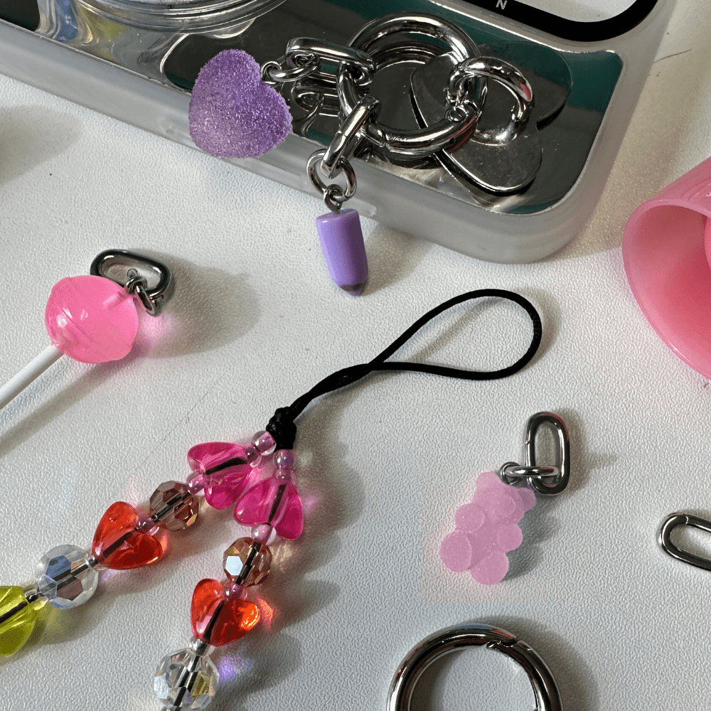Adorable pink bubble bear phone charm, a trendy Y2K aesthetic mobile accessory and decorative strap for phone cases by Build a Caze.