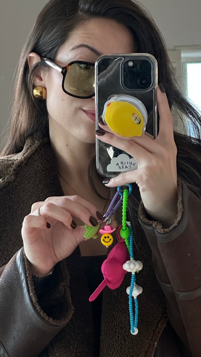Pink clover charm keychain for phone cases and bags, floral aesthetic mobile accessory, cute lucky clover bag charm, trendy pink flower phone decoration, stylish handheld accessory.