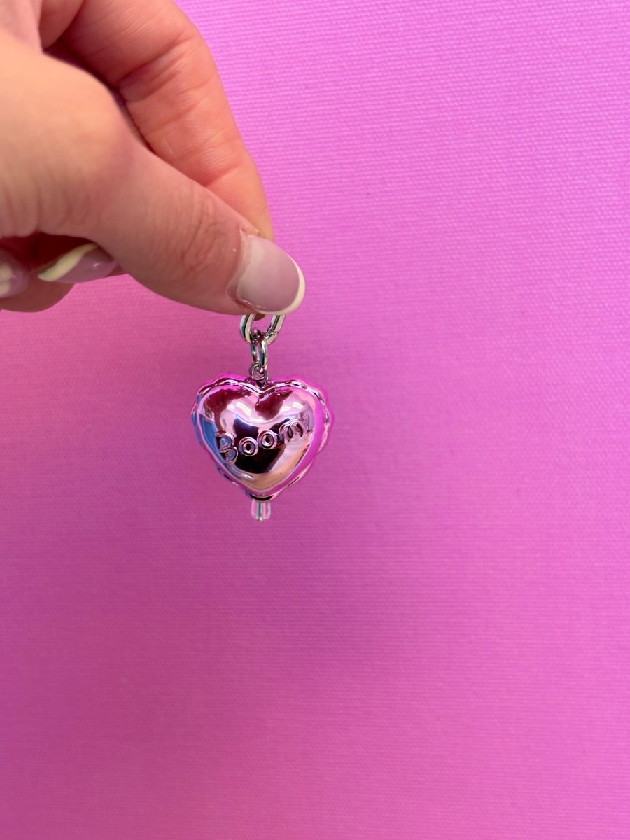 Cute realistic doughnut phone charm featuring a pink glazed design with colorful sprinkles, a miniature sweet treat accessory for mobile phone cases and Y2K aesthetic styling by Build a Caze.