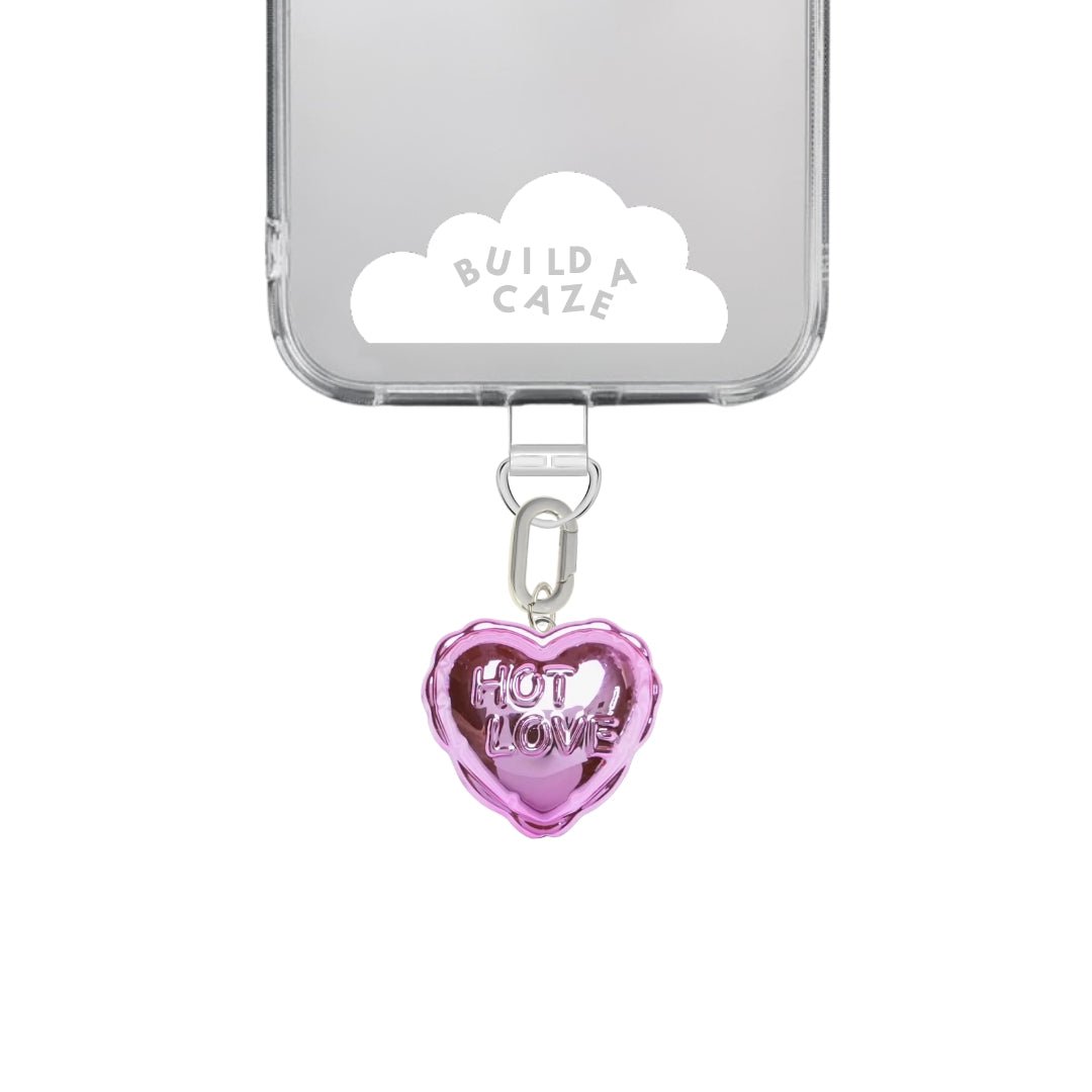 Pink heart-shaped balloon phone charm with a metallic gold and silver finish, cute Y2K aesthetic mobile accessory and decorative tech strap by Build a Caze.