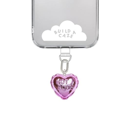 Pink heart-shaped balloon phone charm with a metallic gold and silver finish, cute Y2K aesthetic mobile accessory and decorative tech strap by Build a Caze.